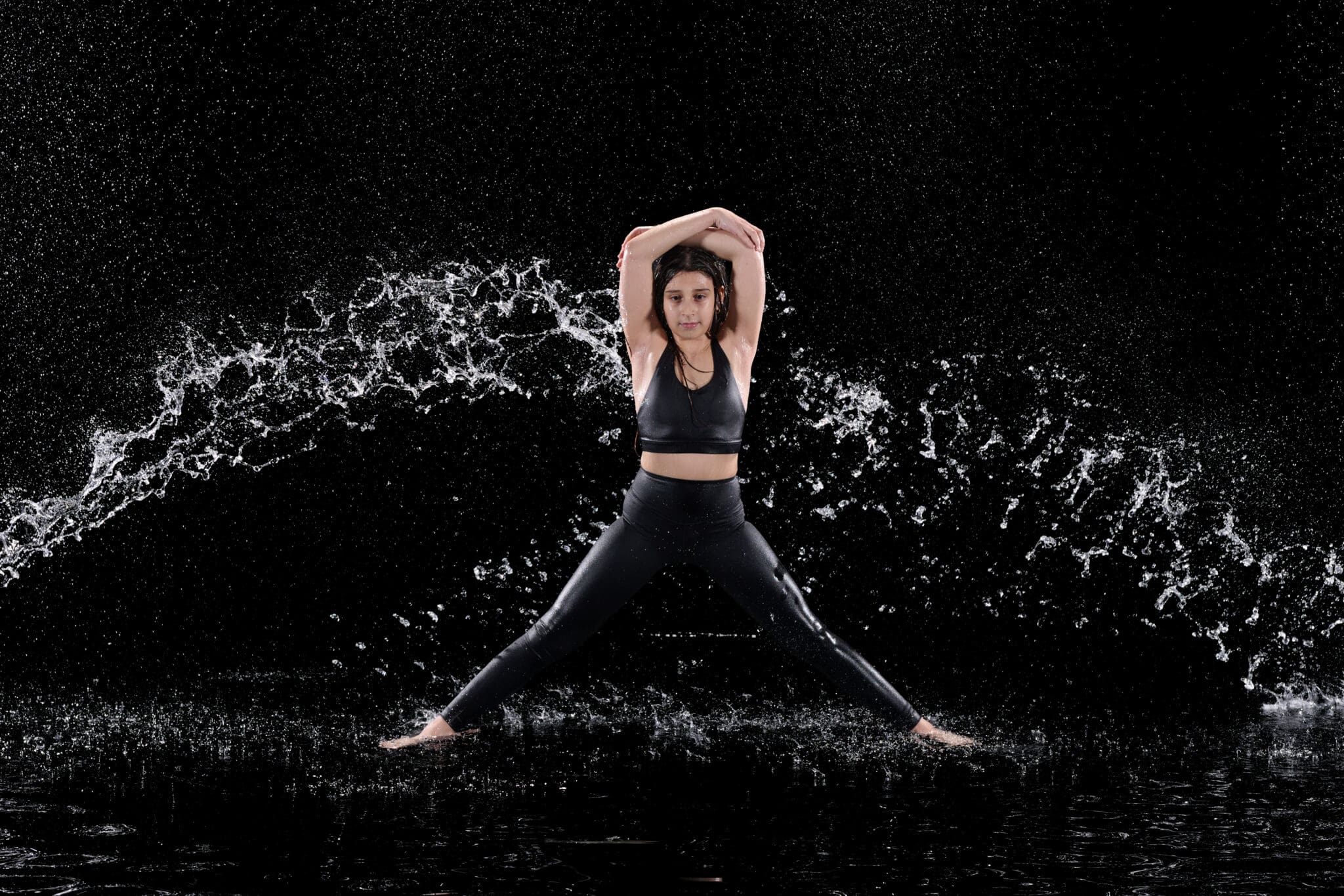 Dancer posing with bold rain indoors